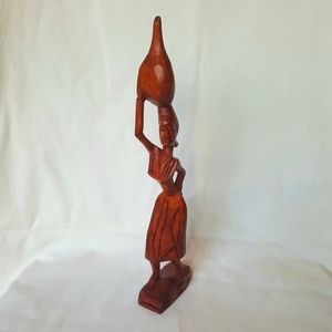 Vintage Wooden Carving. Women carrying jug on head.